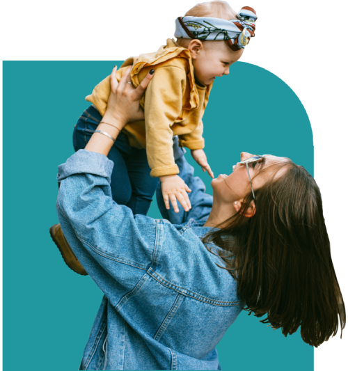 A parent lifting a laughing toddler into the air