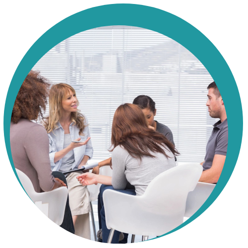 A small group seated in a circle during a workshop